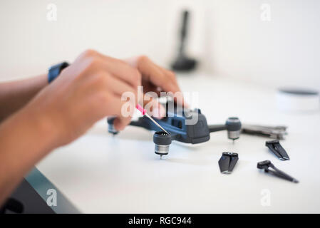 Boy repairing drone Stock Photo