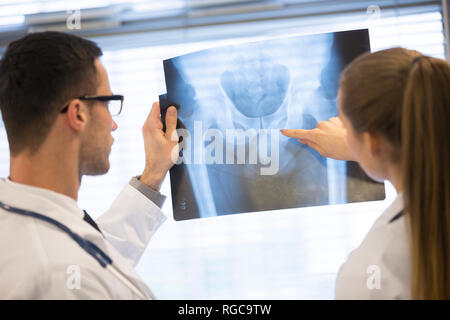 Two doctors discussing x-ray film Stock Photo