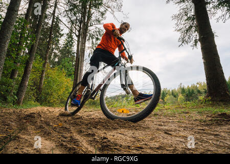 Athlete mountainbiking in the woods Stock Photo