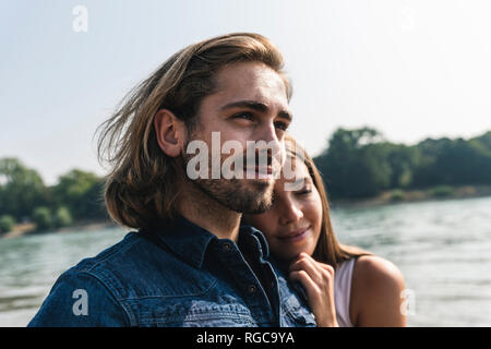 Portrait of young couple in love at the riverside Stock Photo