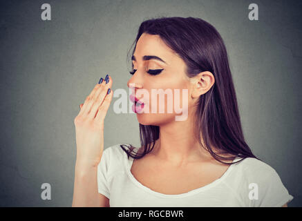 Woman doing a hand breath test Stock Photo