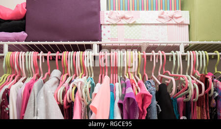 A young girl's closet neatly organized with bins and boxes. Stock Photo