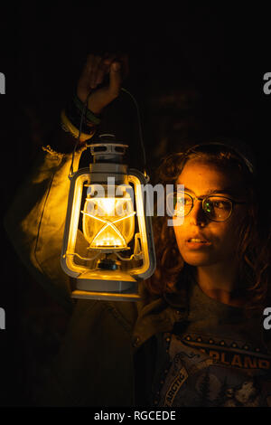 Woman holding lantern in the dark Stock Photo - Alamy