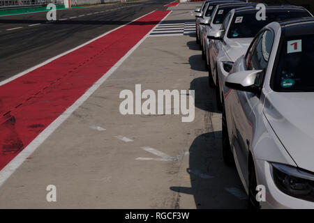 Cars in a row on racetrack Stock Photo