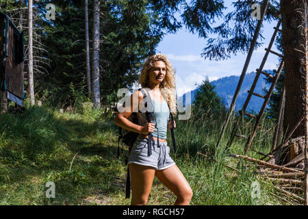 Germany, Bavaria, Oberammergau, young woman on a hiking trip in the mountains Stock Photo