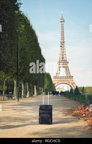France, Paris, Champ de Mars, view to Eiffel Tower with trolley bag in the foreground Stock Photo