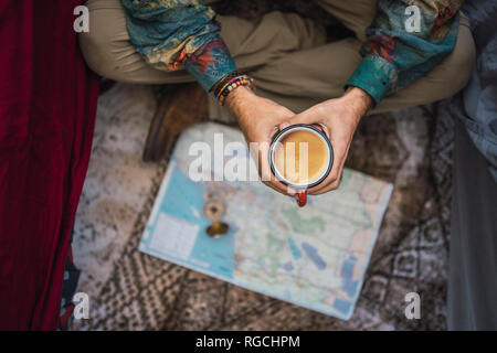 Man drinking coffee over map Stock Photo