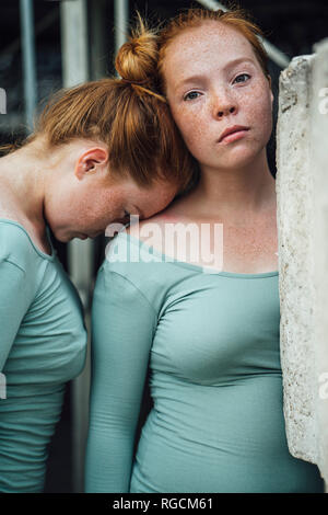 Redheaded twins, head supported Stock Photo