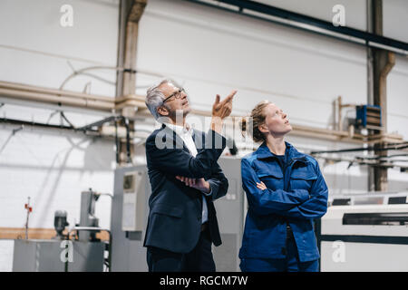 Manager and skilled worker of a high tech enterprise having a meeting Stock Photo