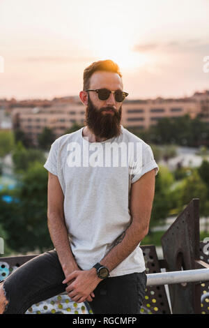 Cool bearded young man wearing sunglasses Stock Photo