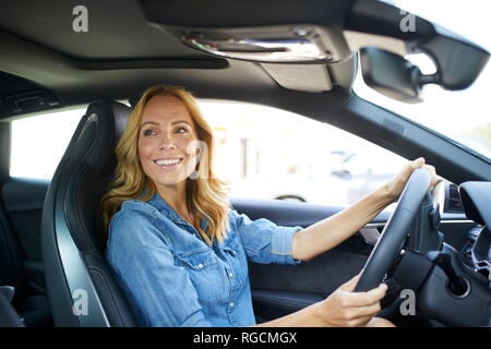 Smiling woman driving car Stock Photo