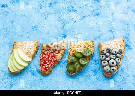Row of bread slices with various toppings Stock Photo