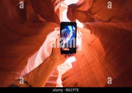 USA, Arizona, tourist in Lower Antelope Canyon, photo on smartphone Stock Photo