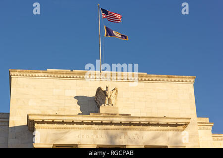 United States Federal Reserve headquarters in Washington DC, USA. Eccles Building with US National and Fed flags under clear sky in early morning. Stock Photo