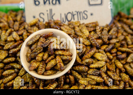 An arrangement of a traditional Thai street food snack of deep fried bugs or insects found in the local market. Stock Photo