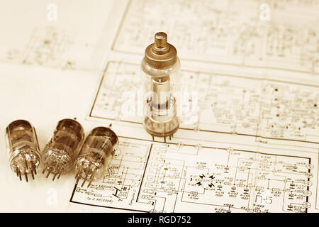 Several vintage electronic vacuum tubes on the old electronic scheme Stock Photo