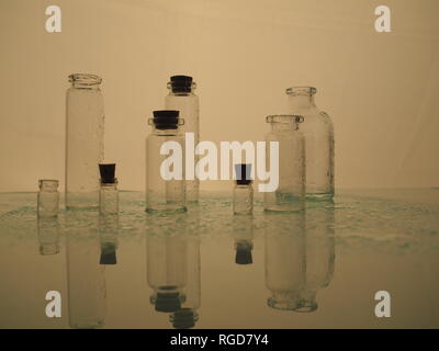 Few transparent bottles, water sprays. empty glass bottles Stock Photo