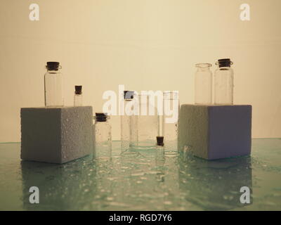 Few transparent bottles, water sprays. empty glass bottles Stock Photo