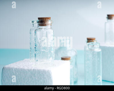 Few transparent bottles, water sprays. empty glass bottles Stock Photo