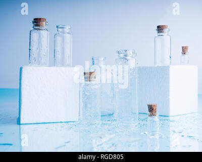 Few transparent bottles, water sprays. empty glass bottles Stock Photo