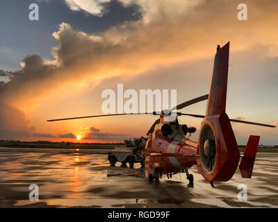 A Coast Guard Air Station Miami aircrew prepares for an evening training flight, Tuesday, June 7, 2018 at Opa-locka Executive Airport in Opa-locka, Florida. Air Station Miami operates a fleet of five MH-65D helicopters and five HC-144 Ocean Sentry aircraft. Coast Guard photo by Petty Officer 2nd Class Christopher Parrinello. Stock Photo