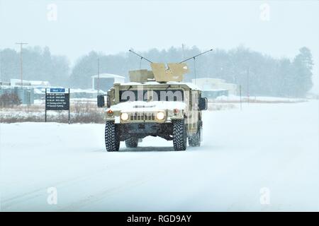 Soldiers at Fort McCoy for training operate an armored Humvee on Jan. 23, 2019, in the snow on the cantonment area at Fort McCoy, Wis. The High Mobility Multipurpose Wheeled Vehicle (HMMWV or Humvee) is a family of light, four-wheel drive, military trucks and utility vehicles produced by AM General. It has largely supplanted the roles previously performed by the original jeep, and others such as the M151 jeep, the M561 Gama Goat, and other light trucks. Primarily used by the United States military, it is also used by numerous other countries and organizations and even in civilian adaptations.  Stock Photo