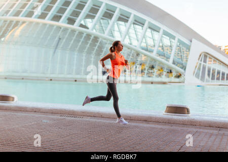Spain, Valencia, woman running at Ciudad de las Artes y de Las Ciencias Stock Photo