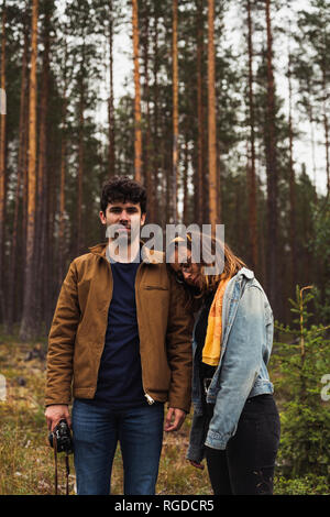 Finland, Lapland, man with camera and woman standing in rural landscape Stock Photo