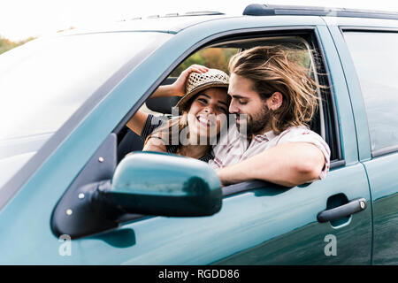 Happy young couple in a car Stock Photo