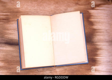 Opened old book with empty pages on wood Stock Photo