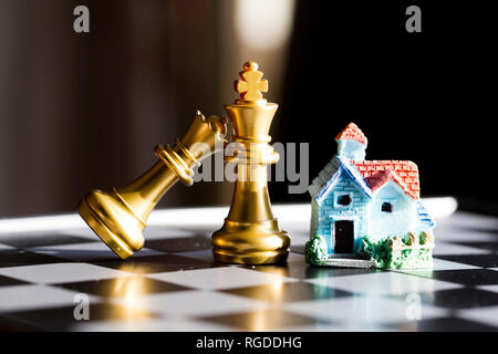 Small house with chess pieces Stock Photo