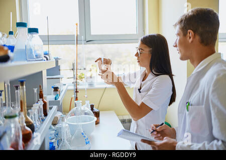 Young man and woman working together in laboratory Stock Photo