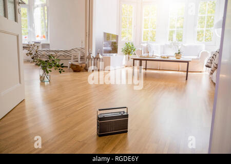 Transistor radio standing on parquet in a modern living room Stock Photo