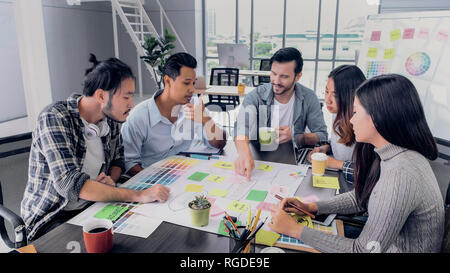 Creative director team lead brainstrom branding project with designer team at meeting table.discussion idea in creative office Stock Photo