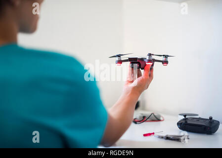 Boy repairing drone Stock Photo