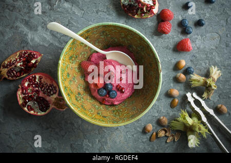 Humus bowl with fruits and nuts, from above Stock Photo