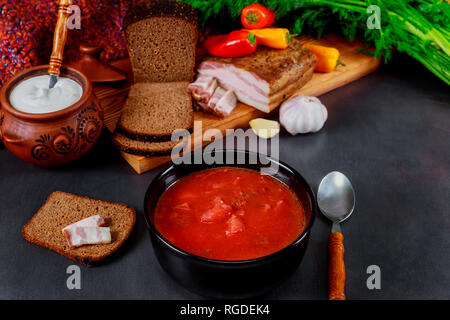 Ukrainian borsch of national kitchen in ceramic bowl with garlic with salted fresh lard Stock Photo