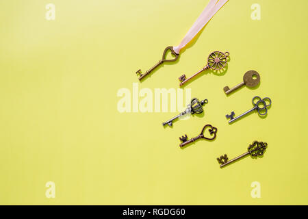 Collection vintage keys isolated . Top view.Antique keys flat lay pattern isolated on yellow background.Creative decorative background for design Stock Photo