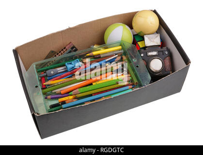 Old forgotten toys and pencils in cardboard box isolated Stock Photo
