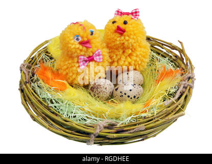 Easter handmade  nest from willow twigs with funny chickens and eggs isolated Stock Photo