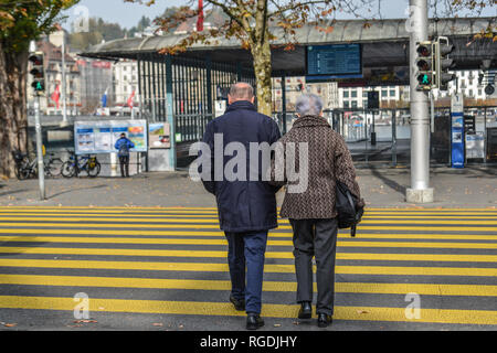 Lucerne, Switzerland - Oct 23, 2018. People walking on the street of Lucerne city along Reuss river coast (Switzerland). Stock Photo