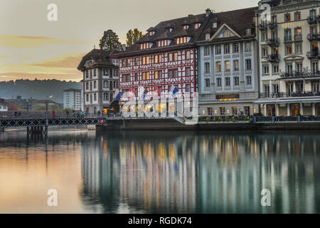 Lucerne, Switzerland - Oct 23, 2018. Views of the famous river promenade of the old town at sunset in Lucerne, Switzerland. Stock Photo