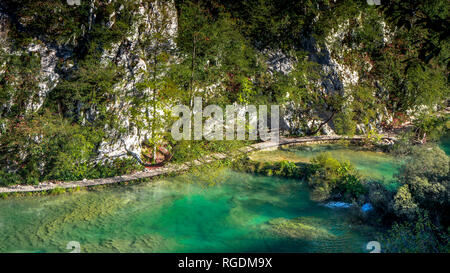 Path along a Lake within the colorful Plitvice National Park in Croatia Stock Photo