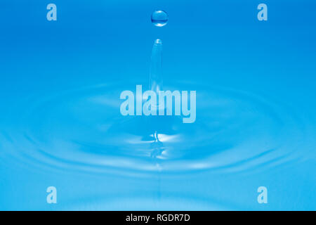 water splash on pure blue water surface Stock Photo