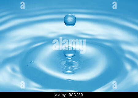 water splash on pure blue water surface Stock Photo