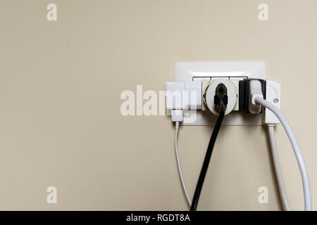 Overloaded electrical outlet in the house Stock Photo