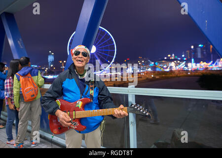 HONG KONG - CIRCA DECEMBER, 2015: an elder man play on guitar Stock Photo