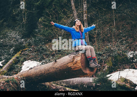 Cheerful woman traveler on vacation camping summer vacations outdoor. Forest in the highlands. Hiking Travel Lifestyle concept summer vacations. Stock Photo