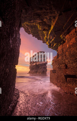 Sunset at Dun Briste sea stack from a cave beneath Downpatrick Head. County Mayo, Ireland.