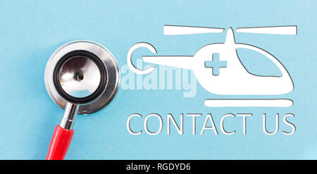 Contact us text with ambulance helicopter as emergency concept on blue background Stock Photo